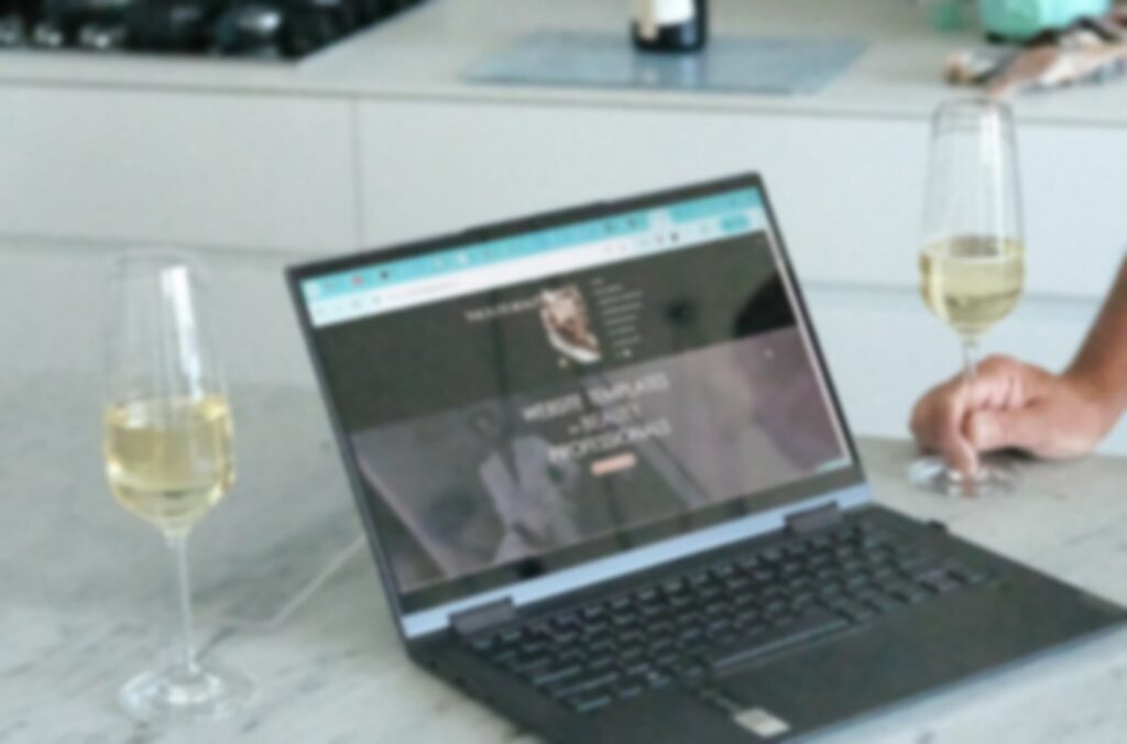 Laptop on a marble bench showing a beauty website, with the note: Four seconds. That's how long a new client gives your first screen.
